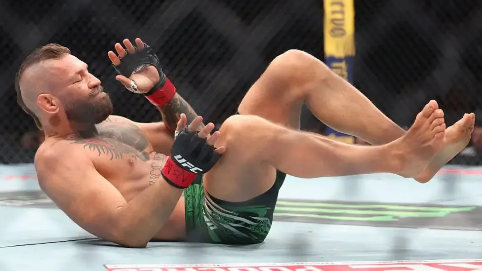 Conor McGregor lies on his back in the octagon